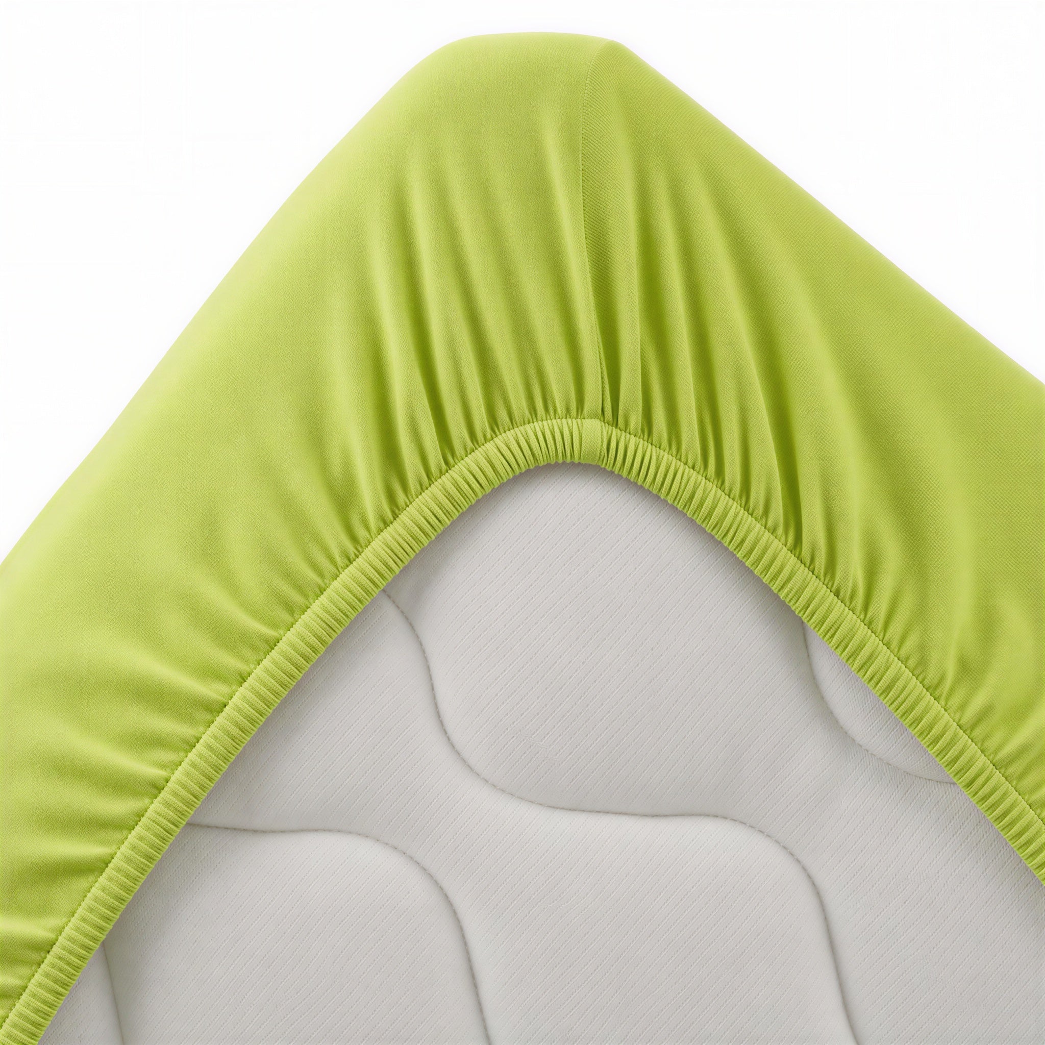 Apfelgrünes Spannbettlaken aufgezogen auf einem Bett im Schlafzimmer
